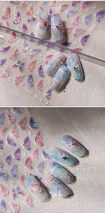 Macro shot of iridescent aurora butterfly nail stickers in pink and blue tones