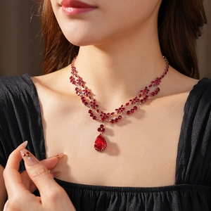 Macro shot of a tiered necklace with teardrop red zircon stones and silver-plated finish