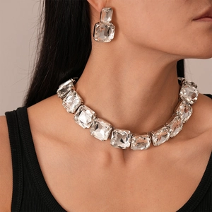Close-up of sparkling square-cut crystal jewelry set featuring choker and stud earrings