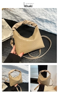Detail view of khaki woven leather bag with unique pleated cloud-shaped handle and strap