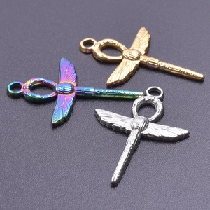 Detailed close-up of Ankh wing pendants in gold, silver, and iridescent finishes