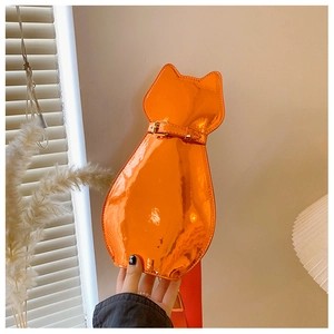 Detailed view of glossy orange cat-shaped bag with reflective patent finish and wide strap