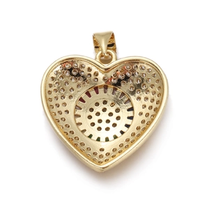 Macro detail of gold plated heart pendant back featuring intricate hollow out patterns