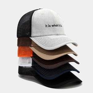 Stack of breathable mesh trucker hats with 'it is what it is' letter print embroidery