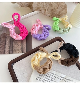Detailed close-up of colorful braided hair ties with rabbit ear knots in various shades