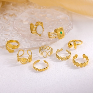 Set of 9 vintage gold-finished rings featuring turquoise, shells and leaf designs