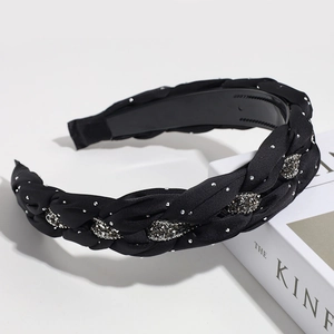 Detailed view of wide braided headband with crystals and non-slip interior teeth