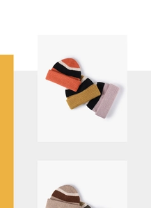 Detail of colorful striped thick knit beanies showing texture and warm ribbed cuff design