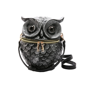 Black owl shaped crossbody bag with embossed feather texture and golden zipper