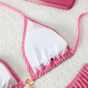 Detail of pink bikini top interior with breathable mesh lining and removable pads