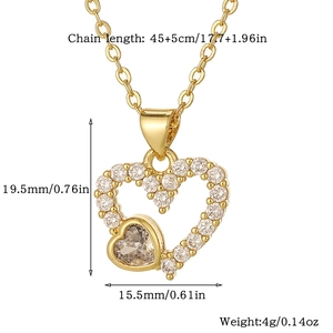 Macro detail of gold heart pendant with white zircon inlays and product dimensions