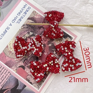 Macro view of 30x21mm bow accessories with red rhinestones for DIY jewelry making