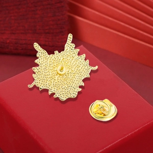 Back view of golden dragon brooch with butterfly clutch on a red gift box