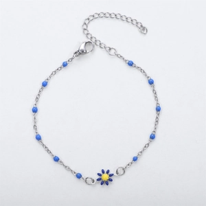 Detailed view of silver bead chain bracelet featuring blue daisy pendant and lobster clasp