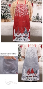 Detail of Christmas linen apron featuring festive gnome prints and dual front pockets