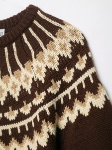 Detailed close-up of dark brown Fair Isle knit sweater with geometric patterns and S size tag