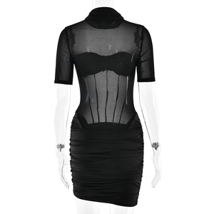 Detail of black mini dress featuring sheer mesh sleeves and ruched bodycon skirt design