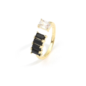 Golden open ring with four black rectangular stones and a clear square zircon on white base