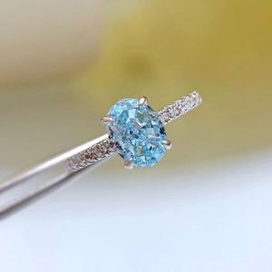 925 silver ring with oval light blue zircon and micro-paved side stones in four-prong setting