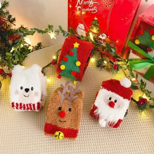 Plush Christmas socks close-up, thick coral fleece warm winter socks with cute cartoon holiday details.