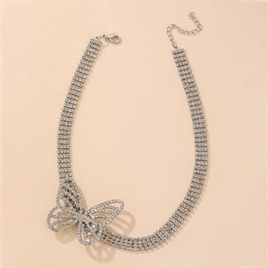 Detail of four-row rhinestone choker necklace featuring a large sparkling butterfly charm