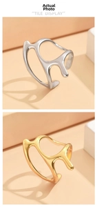 Vertical display of irregular liquid metal rings in polished gold and silver finishes