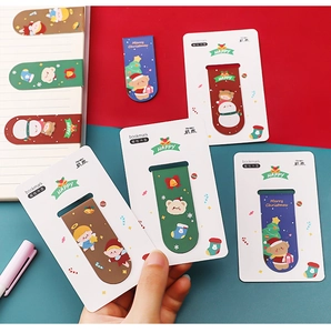 Close-up of cute Christmas magnetic bookmarks featuring Santa and Reindeer designs