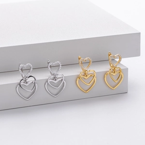 Macro detail of S925 silver stamp on heart-shaped earrings with zircon inlay