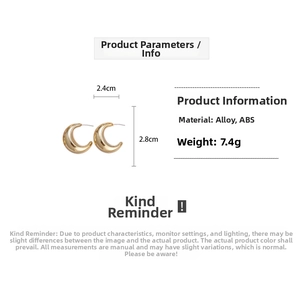 Detail view of gold C-shaped drop earrings showing dimensions 2.4cm width and 2.8cm height
