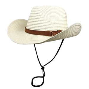 Detail of raffia straw hat showing beige woven texture and brown suede belt with gold buckle
