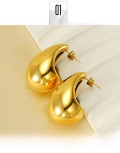 Detailed view of polished gold-plated teardrop earrings showing high-shine mirror finish