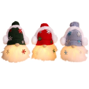 Three glowing LED Christmas gnomes in red, green, and blue knitted hats for decor