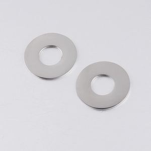 Macro detail of high-polished stainless steel round pendants with smooth mirror finish