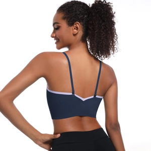 Detail of V-shaped open back sports bra with contrast purple trim and adjustable straps