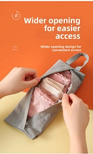 Detail of grey waterproof storage bag showing wide opening for organizing bras