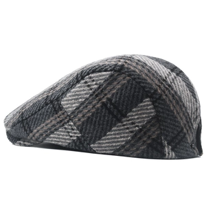 Macro shot of grey plaid tweed flat cap showing thick vintage wool texture and patterns