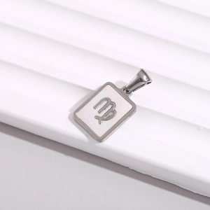 Detailed close-up of a square stainless steel Virgo zodiac pendant with white inlay