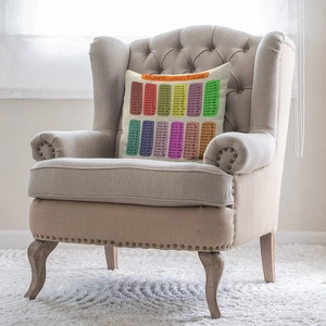 Educational multiplication table printed cushion on armchair in a cozy bright room
