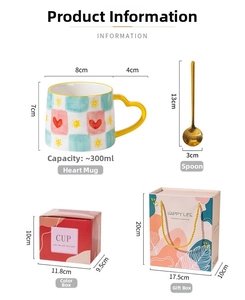 Detailed view of checkered ceramic mug with heart handle, gold spoon and gift packaging