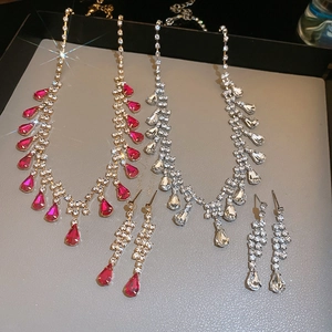 Close-up of gold and silver plated jewelry sets with sparkling teardrop crystal tassels