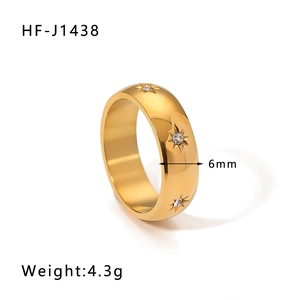 Detail view of 6mm gold stainless steel ring with star pattern and diamond inlay