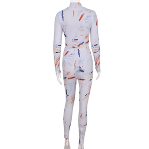 Rear view of tight-fitting jumpsuit with colorful orange and blue abstract ink patterns