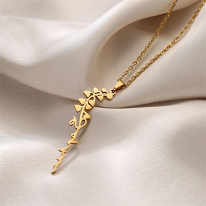 Macro detail of custom Arabic calligraphy pendant on a delicate gold stainless steel chain