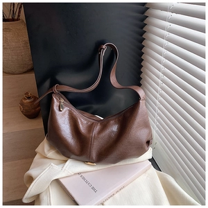 Detailed view of dark brown textured PU leather hobo bag with sleek crescent shape