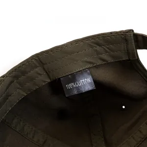 Detail view of cotton baseball cap care label showing 100% cotton material and stitching
