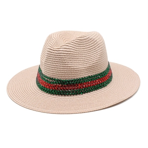 Detail of beige woven straw fedora hat with red and green rhinestone band decoration