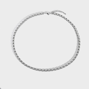 Detail of silver stainless steel chain necklace with square texture and lobster clasp