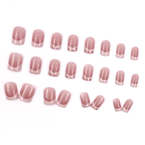 Short round French press-on nails with nude pink base and sparkling gold glitter accents