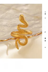 Macro detail of 18K gold snake ring showing intricate scale textures on a satin background