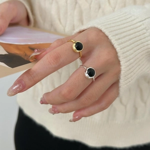 Detail of vintage S925 silver rings with black agate stones worn on hand